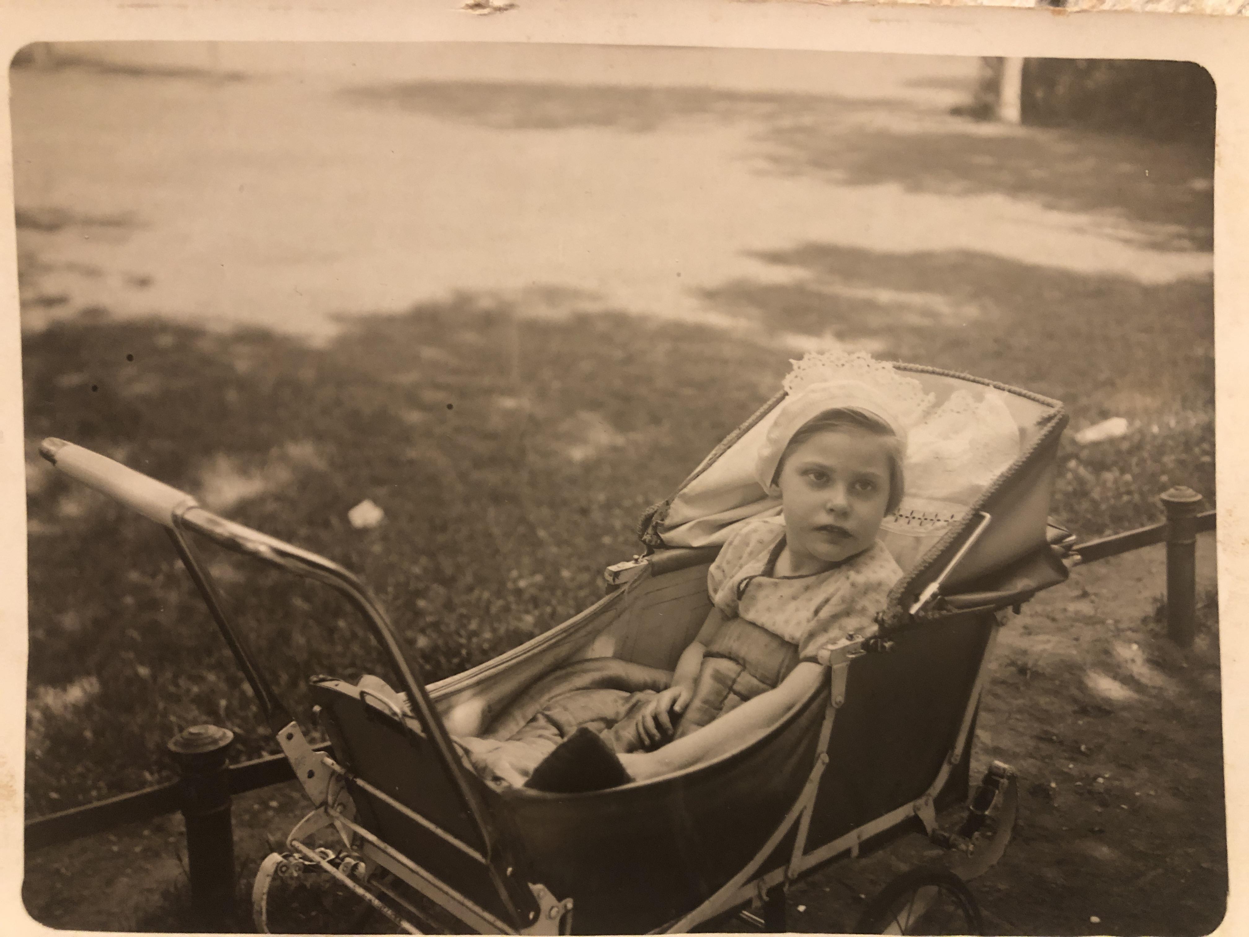 Photo of a girl sitting in a pram